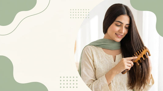 Woman combing smooth hair with a wooden comb