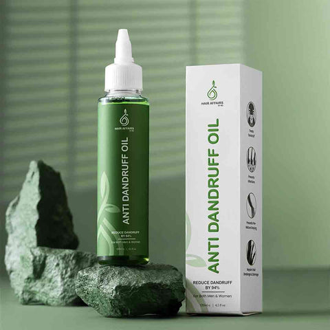 Anti dandruff oil bottle and packaging on a green background